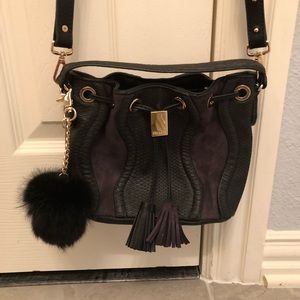 Black Steve Madden bucket purse with pom pom charm